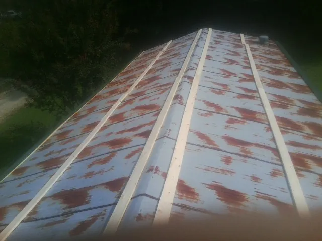 Rusted metal roof panels with new wood purlins before replacement — Storm Damage Roof Repair in Asheville by Roofing Brothers
